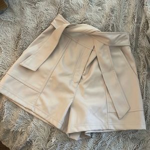 Cream colored pleather shorts with tie! NWT. Small. Elastic waist.